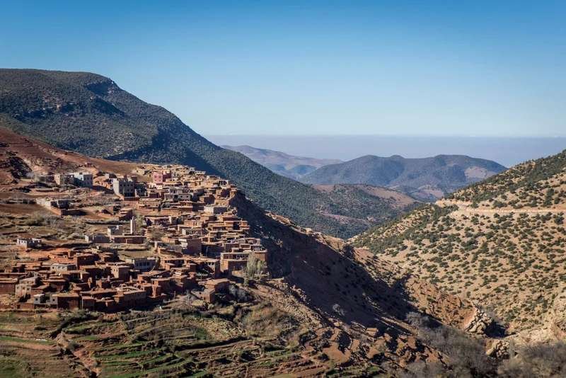 Traditional Berber village nestled in the Atlas Mountains with terraced fields.