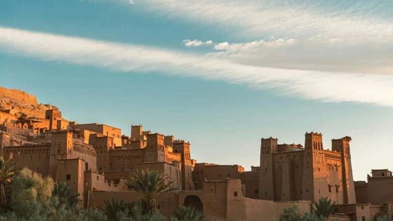 Ancient Ait Benhaddou kasbahs nestled in Morocco's Atlas mountains at golden hour